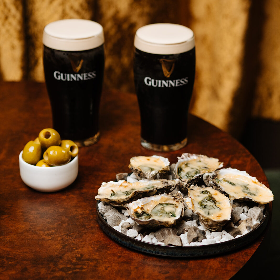 Two pints of Guinness with oysters and olives at The Mercantile Hotel, one of the best bars in Dublin city centre