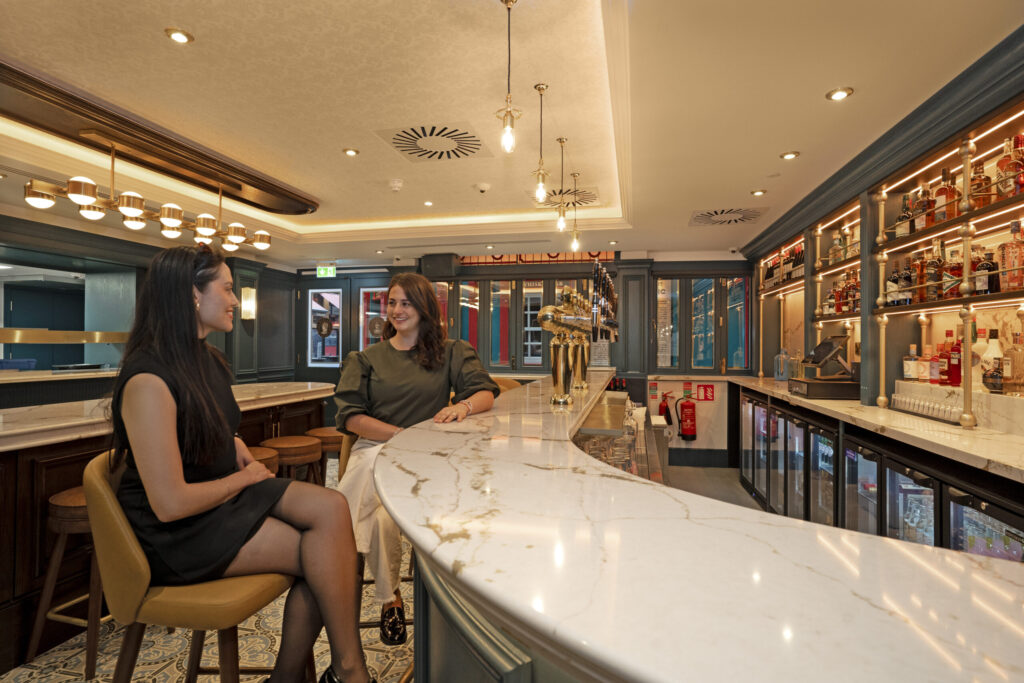 Mercantile Hotel Whiskey Bar | Stylish hotel bar with gold accents and high stools at The Mercantile Hotel, one of the best bars near Temple Bar Dublin.