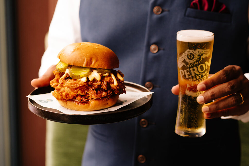 NASHVILLE HOT CHICKEN SANDWICH, served with pickles, hot honey ranch, slaw, fries from The Mercantile Hotel, the best food in the city . If you're looking for where to eat in Dublin, save your spot here 